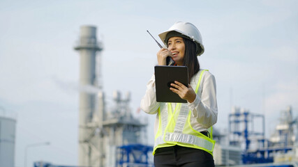 Industrial engineer using digital tablet for work against the electrical plant