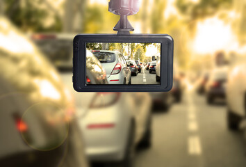 Modern dashboard camera mounted in car, view of road during driving