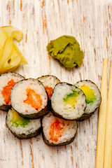 Rolls with salmon, cucumber and avocado.