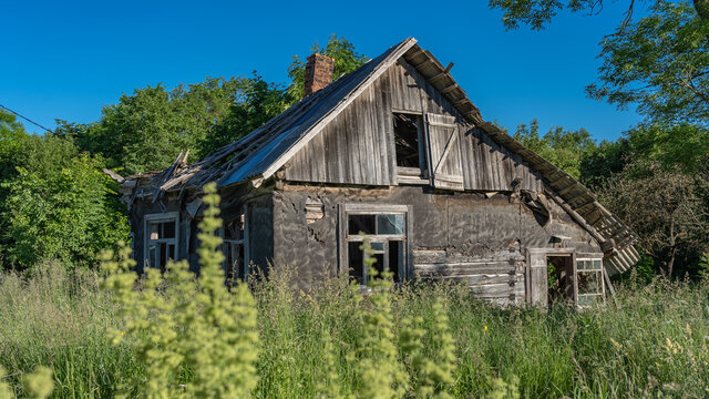 An old abandoned farmhouse. Broken windows. Broken roof.