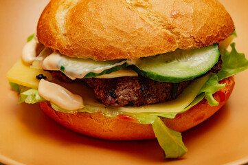 Closeup of home made burger. Burger on a beige plate. food.