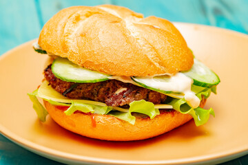 Closeup of home made burger. Burger on a beige plate. food.