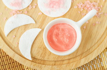 Small porcelain bowl with rose jelly face or eye mask and cotton eye patches. Natural skin care,...