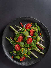 Healthy chopped vegetables on a plate, vertical orientation, copy space, top veiw