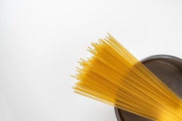 raw traditional italian pasta spaghetti in the pan, cooking the food