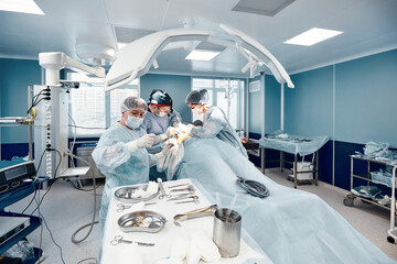 A modern operating room, surgeons and doctors doing an oncological operation, modern medicine, a...