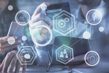 Double exposure of man and woman on-line shopping holding a credit card and social network theme hologram drawing. People connecting and E-commerce pay on-line concept.