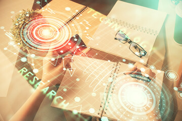 Double exposure of woman on-line shopping holding a credit card and data theme hologram drawing. E-commerce concept.