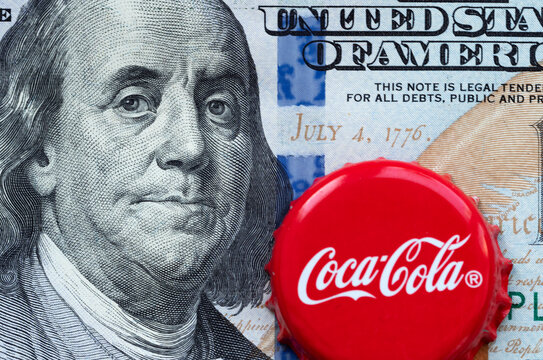 In this photo illustration Coca-Cola corck on the background of a 100 dollar bills