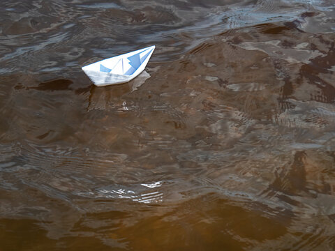 White Paper Boat On The Water Surface