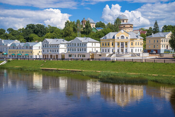 Fototapeta premium City embankment of the Tvertsa river on a sunny July day. Torzhok, Tver region. Russia