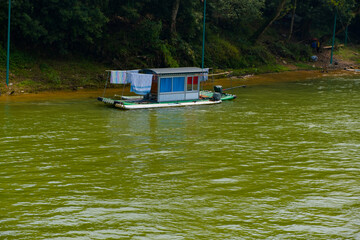 Floating living house of fisher on boat at the river Guilin area, China, interesting place for travel, cruise, fishing