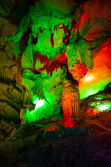 Nice cave formed by nature with stalactites, stalagmites, karst limestone