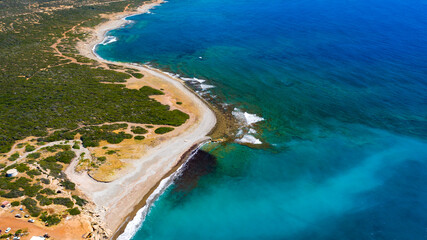 Aerial view of coastline of Cyprus beach.The steep stone cliffs and deep blue sea waves crushing in coves. beautiful turquoise waters of mediterranean