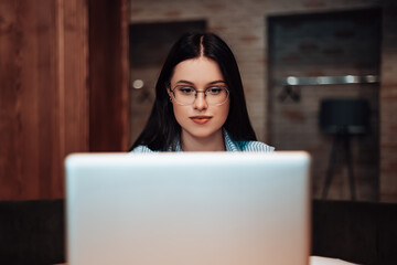 Caucasian woman sitting cafe coffee break open space work laptop have lunch documents free Wi-Fi. Lady dressed striped shirt stylish glasses speaking with colleagues video voice chat copyspace