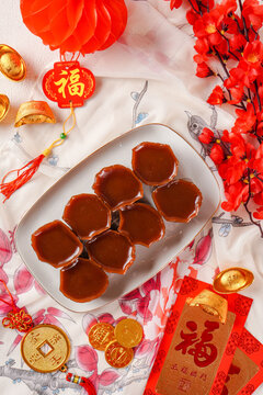 Nian gao or Kue Bakul is a food prepared from glutinous rice flour and consumed in Chinese cuisine. In Indonesia, it is known as Kue Keranjang and shoot with chinese ornament