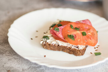 Cooked breakfast with coffee and sandwich. All this on a gray background