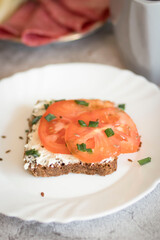 Cooked breakfast with coffee and sandwich. All this on a gray background