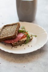 Cooked breakfast with coffee and sandwich. All this on a gray background