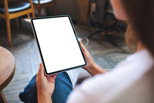 Mockup image of a woman holding digital tablet with blank white desktop screen