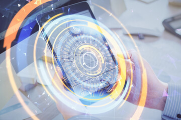 Double exposure of man's hands holding and using a digital device and tech theme hologram drawing. Technology concept.