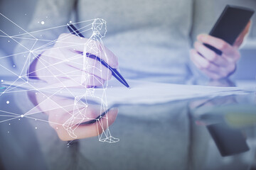 Double exposure of creative hologram and woman holding and using a mobile device. Start up concept.