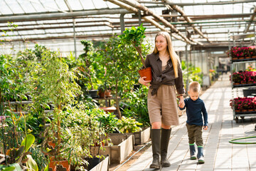 Mom and son walk in the greenhouse