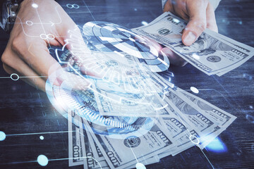 Multi exposure of technology drawing hologram and us dollars bills and man hands. Data concept