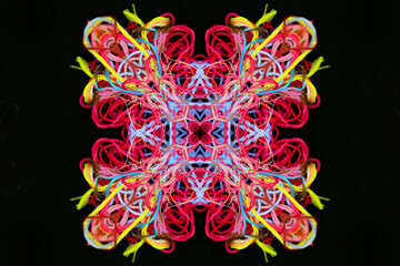 Abstract shape from multicolored threads on a black
