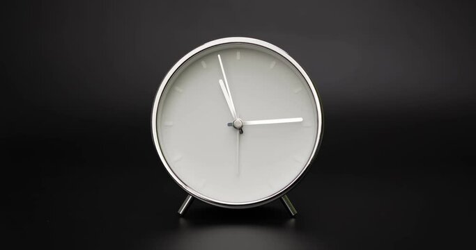 silver clock isolated on black background, Time starts walking at 11 o'clock, Time lapse 3 hour.