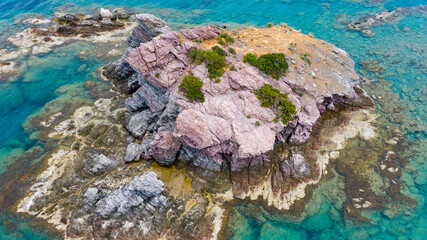 Aerial view of coastline of Cyprus beach.The steep stone cliffs and deep blue sea waves crushing in...