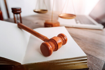 Justice and law concept.Male judge in a courtroom with the gavel, working with, computer and...