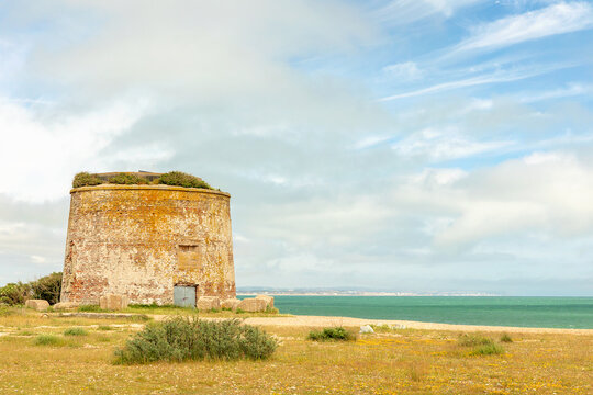Martello tower on the beach with copyspace, blue sky