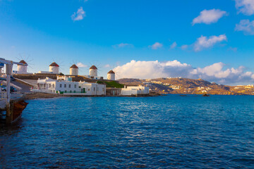 Widnmills view from distance with cloudy sky from the heart of Little Venice in Mykonos Island Cyclades Greece - 440253154