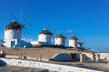 Windmills in a row at midrange shoot with blue sky in Mykonos island cyclades Greece - 440253325