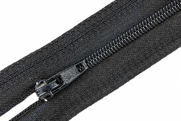 a black zipper shot on a white background, close up, macro shot © Jackie Matthews 