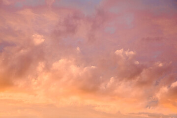 Naklejka na ściany i meble Orange sky at sunset. Yellow and pink clouds in the sky. Abstract background.