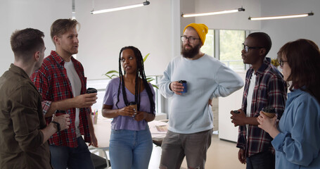 Successful business team talking on coffee break.