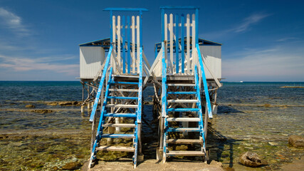 Front view of beach colorful stilt houses also called palafitte in the seaside of Santa Marinella , Rome , Italy