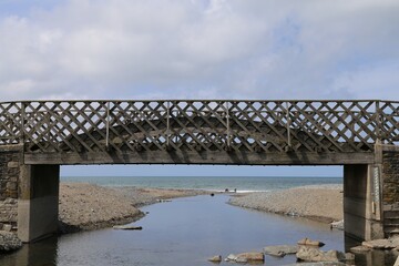 The wooden bridge over the Clarach river on the Ceredigion coast in Wales, UK.