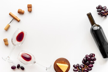 Wine in glass and bottle with corks and grape