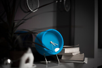 blue alarm clock on the windowsill