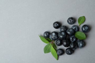 Fresh blueberry with leaves on gray background