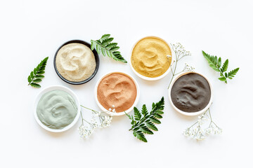 Cosmetic clay powder and mask in bowls, top view