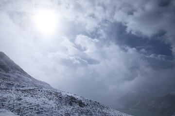Snowing high altitude mountains on winter day