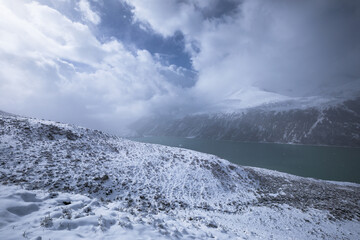 Fototapeta na wymiar Snowing high altitude mountains on winter day