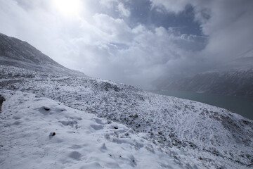 Snowing high altitude mountains on winter day