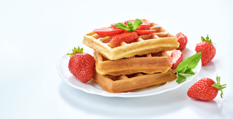 Breakfast with freashly baked belgian waffles on white background copy space.