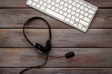 Communication support call center. Voip headset and computer laptop, top view