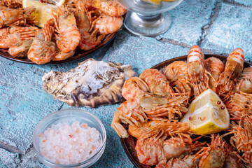 Two plates with cooked greenland prawns and lemon close-up. © Alexandr Milodan